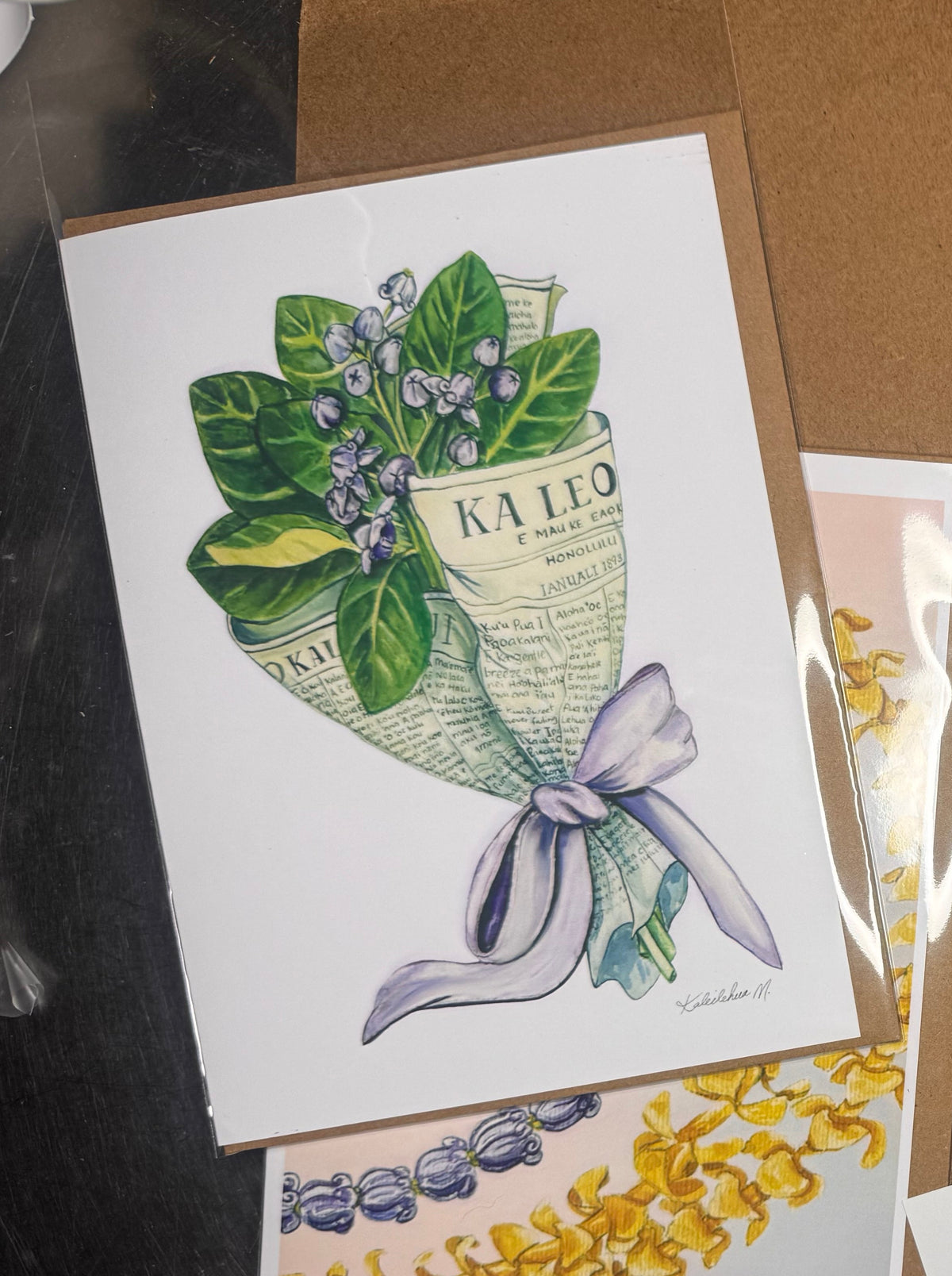 Greeting card of original watercolor of crown flower painting wrapped in newspaper 